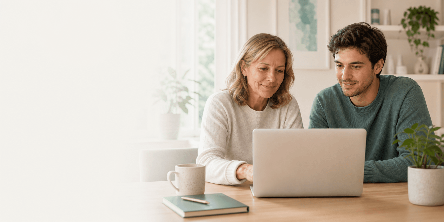 A parent and adult child reviewing privacy choices on a laptop